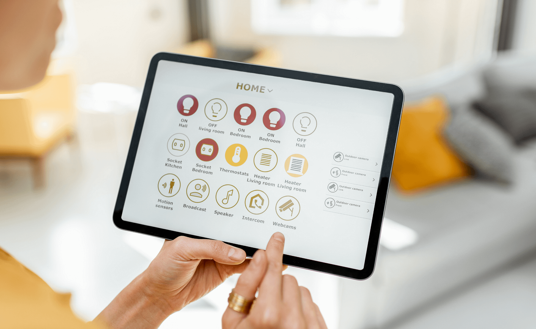 Person controlling smart home devices through a tablet interface