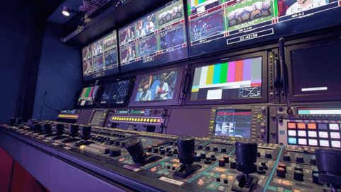 Engineer working with broadcast equipment in a professional studio environment
