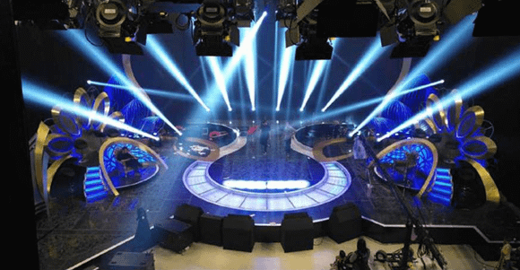 TV show set design with seating and decorative panels under studio lighting